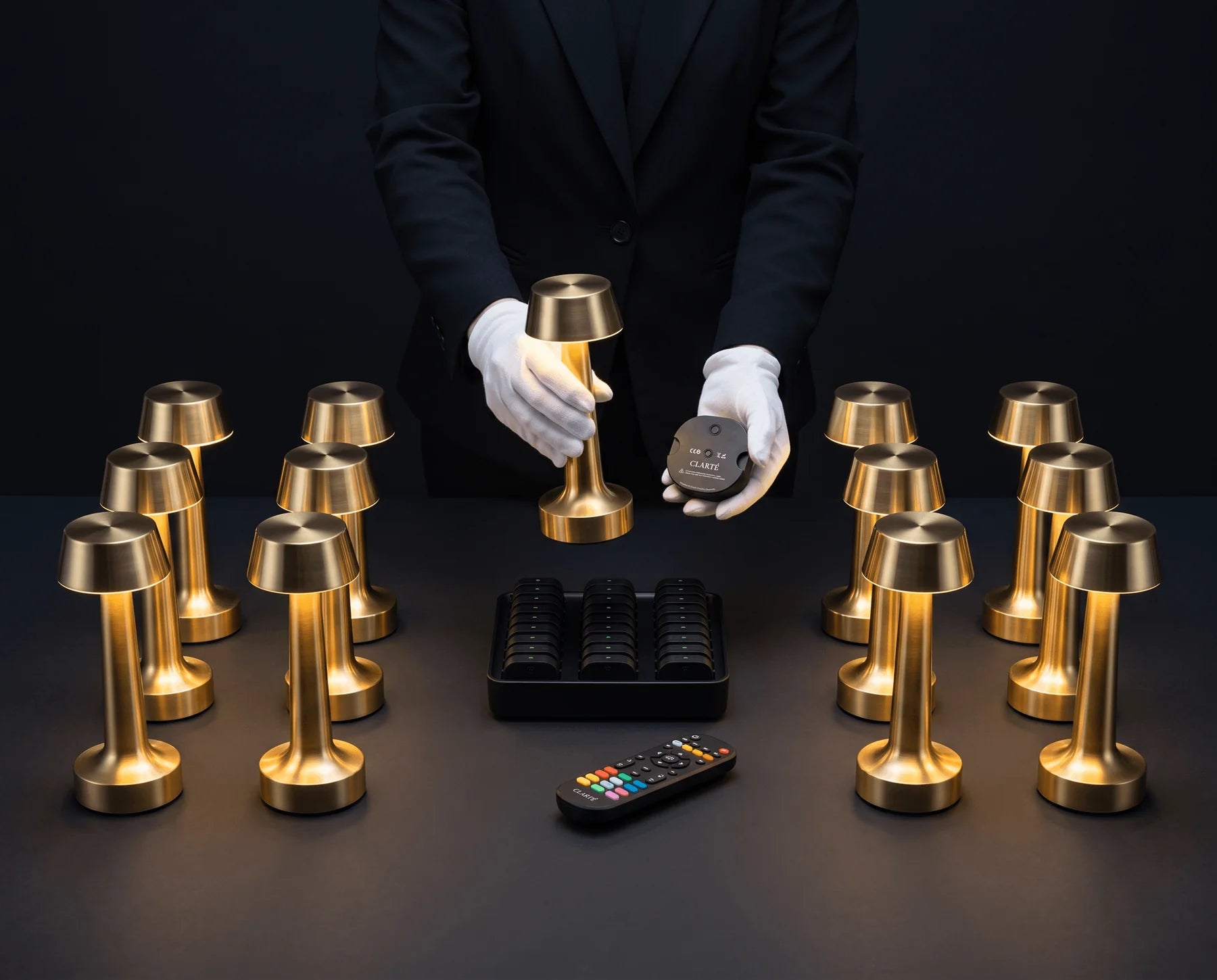 A Clarté lamp, its modular battery, the charging dock and the remote